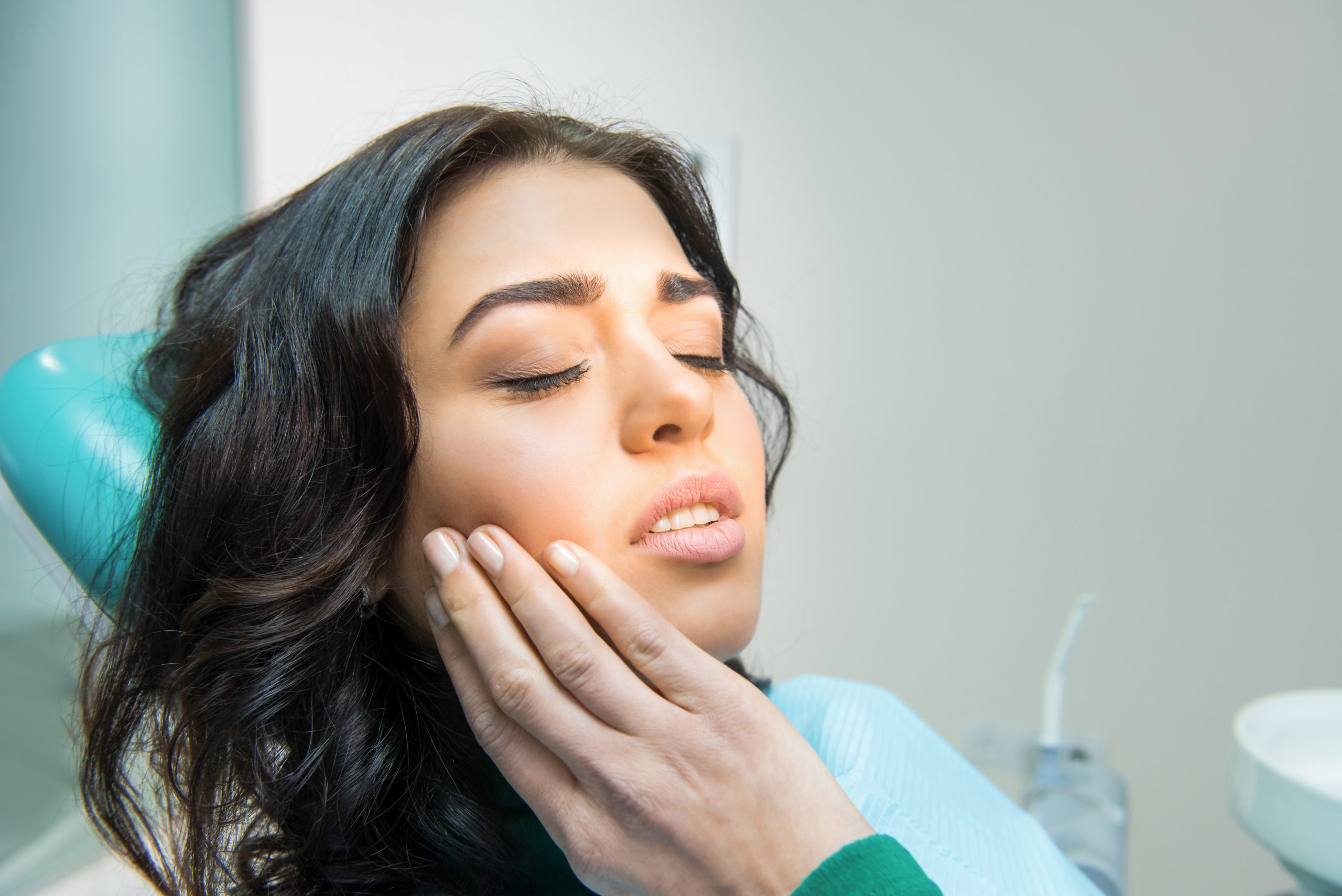 Young woman having toothache.